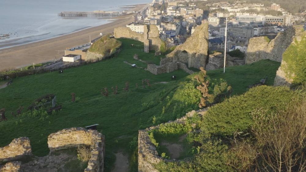 The castle ruins on the West Hill, with the town and the sea below
